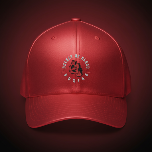Red embroidered Bucket of Blood cap, mid-profile red baseball hat with six-panel construction, curved visor, and subtle center embroidery