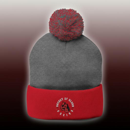 Embroidered knit cap with hand-stitched emblem and puffed pom, cozy pom-pom beanie for winter, soft and stretchy beanie